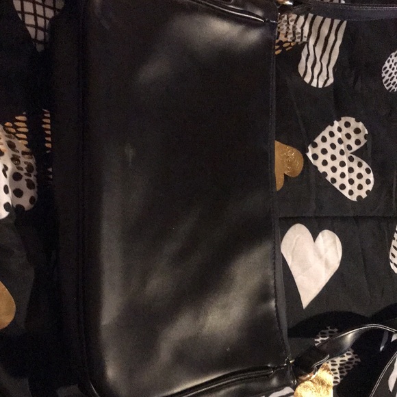 Black with gold tone hardware and faux leopard fur accents. Purse - Picture 4 of 5